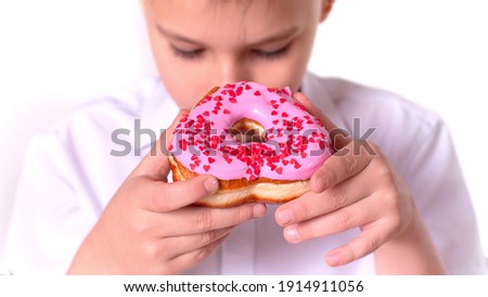 pink donut in the shape of a heart in children's hands . saint valentine