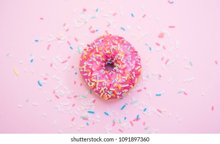 pink donuts with sprinkles on pink background