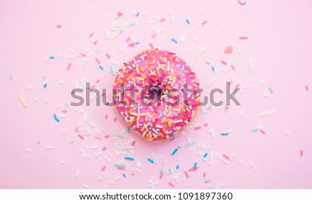 pink donuts with sprinkles on pink background