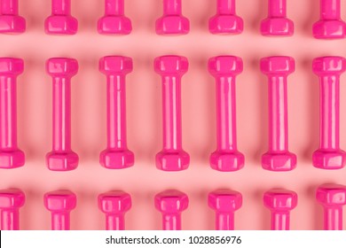 Pink Dumbbells On  Pink Background Isolated Pattern 