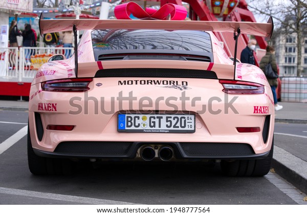 Pink easter Porsche\
racing car parked at city of Zurich. Photo taken April 3rd, 2021,\
Zurich, Switzerland.