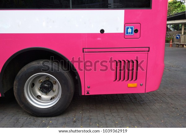 The pink electric shuttle bus which have plug\
symbol is waiting for the passenger, in concept of clean energy,\
electric bus, innovation