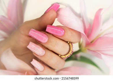 Pink elongated nail extension with fine glitter. - Shutterstock ID 2156748599