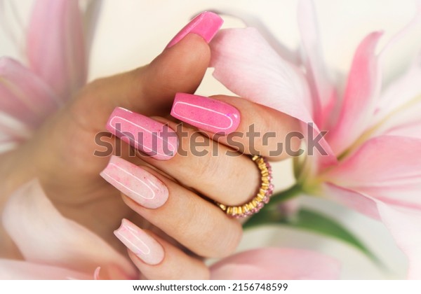 Pink\
elongated nail extension with fine\
glitter.