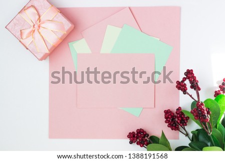 Pink empty card, sheet for writing. Layout for adding tags with gift box and bouquet of flowers . Top view, flat lay, copy space