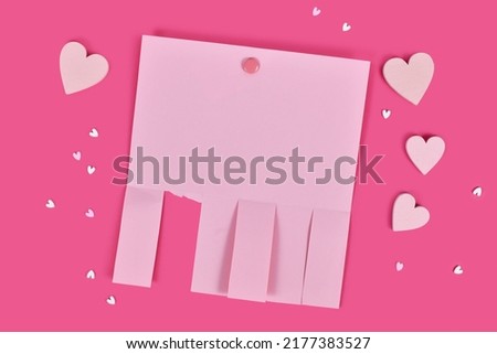 Pink empty tear-off stub paper note without text with heart ornaments