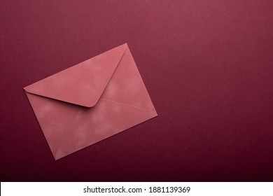 Pink Envelope For St. Valentines Day Letter On A Burgundy Background