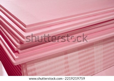 Pink Extruded Polystyrene XPS foam thermal insulation boards stacked in the construction site. High Density, water absorption. Eco energy saving technology