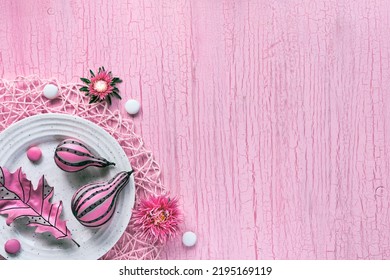 Pink Fall Decor. Panoramic Banner Image. Stripy Pumpkins, Dry Autumn Leaves, Flowers On A White Plate. Fuchsia Painted Objects On Pink Textured Background. Monochromatic Flat Lay, Copy-space.