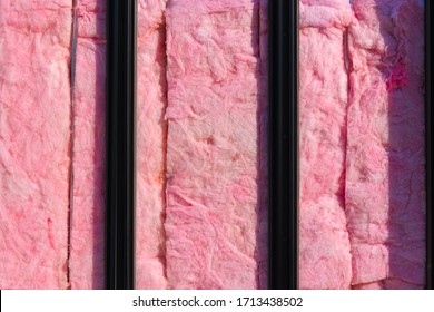 Pink fiberglass against glass windows on new construction on business opening in Seattle Washington. insulation while building is vacant and unoccupied. 