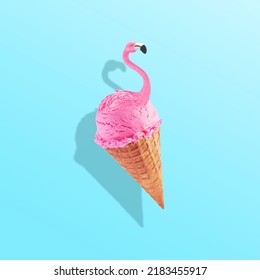 Pink Flamingo In Ice Cream Waffle Cone. Minimal Abstract Caribbean Concept Of Summer And Vacation In The Tropics By The Sea, A Trendy Collage On A Blue Background.Creative Art Minimal Aesthetic