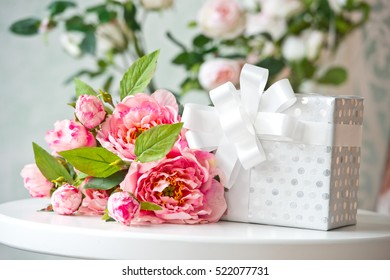 Pink Flowers And Gift Box On The Table. Birthday. Interior