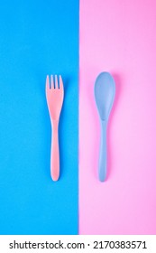 Pink Fork And Blue Spoon On Two Colored Background. Flat Lay With Reusable Utensils Made Of Wheat Straw