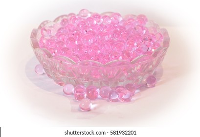 Pink fragrant droplets in a small glass bowl