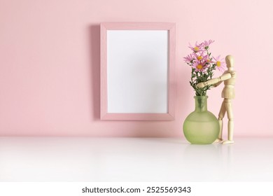 Pink frame with pink flowers in green vase on white table background. Side view, copy space, still life, mockup, template, spring, summer minimalism concept - Powered by Shutterstock