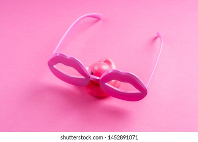 Pink Funky Rubber Duck Wearing Lip Shape Glasses On Neon Monochrome. Pop Art Item Composition.