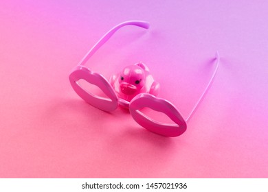 Pink Funky Rubber Duck Wearing Lip Shape Glasses On Neon Monochrome. Pop Art Item Composition.