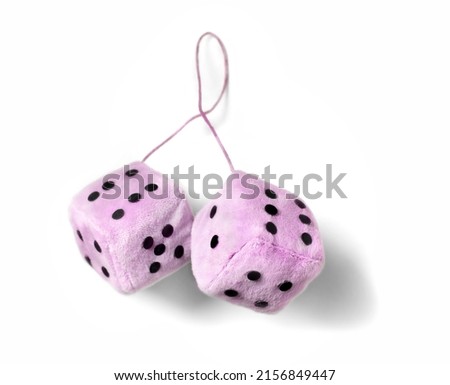 A pink fuzzy dice isolated on a white background