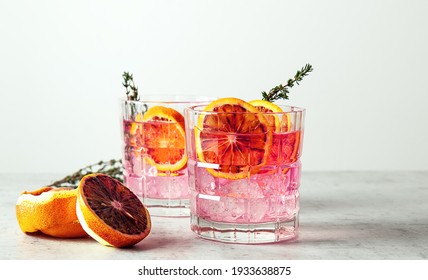 Pink Gin Cocktail With Red Blood Orange And Ice. An Alcoholic, Refreshing Drink. Copy Space.