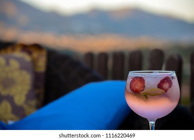  Pink Gin And Tonic With Strawberry In The Glass With Spanish Countryside Background.