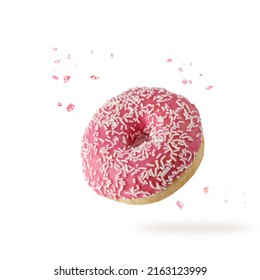 Pink Glazed Single Donut With White Sprinkles And Crumbs Flying. Sweet Doughnut Closeup Isolated On White Background