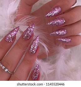 Pink Glitter Nails On White Feather Background