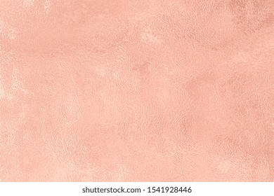 Pink gold foil paper decorative texture background for artwork. Rose gold pink texture metallic wrapping foil paper shiny metal background for wall paper decoration element. Gold foil texture design.