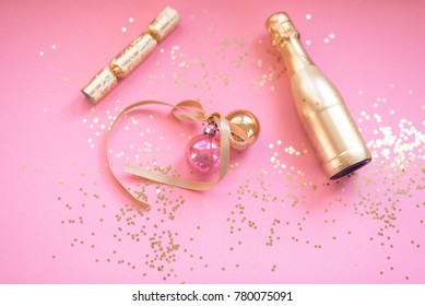 Pink and gold party background with glitter confetti and champagne