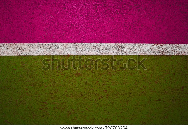 Pink and\
green background, texture of the\
road\
