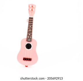 pink guitar toy isolated on white background