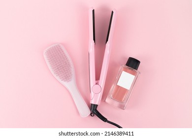 Pink Hair Brush, Pink Hair Straightener, Pink Perfume Mockup On Pink Background.