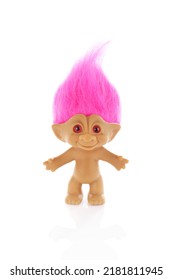 Pink haired troll or elf doll on a white background