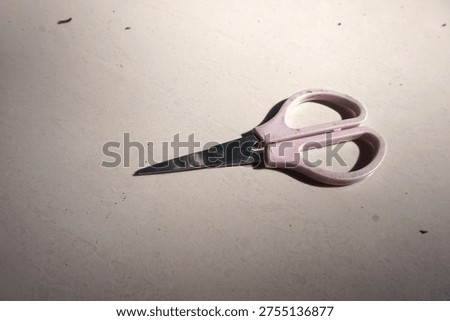 Pink Handled Scissors on Light Background