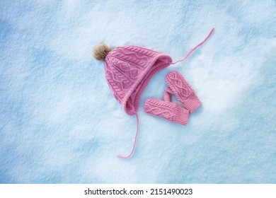 Pink Hat And Mittens In The Snow, Clean View From Above, Winter Holidays Concept