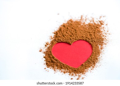 A Pink Heart On Brown Powder On White Bac