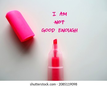 Pink highlight pen with text written on white paper I AM NOT GOOD ENOUGH, changed to I AM GOOD ENOUGH, concept of overcome negative inner voice and change to positive self talk to boost self esteem - Shutterstock ID 2085119098