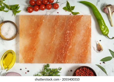 Pink himalayan salt block for cooking and serving and herbs and spice around. Food background with copy space - Powered by Shutterstock