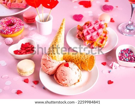 Pink ice cream cones with red sugar hearts shaped sprinkles. Valentines day concept
