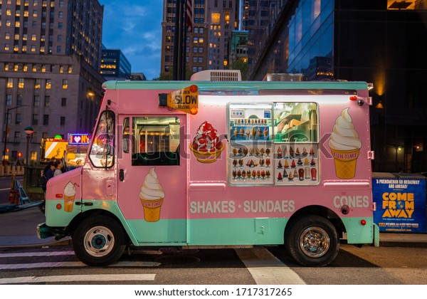 Pink ice cream\
truck on a street in New York at dusk - May 29, 2019, Battery\
Plaza, New York City, NY,\
USA