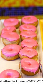 Pink Iced Donuts In Display Case