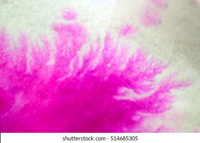 Pink Ink Spread and Absorbed Over White Close-up Paper. Abstract Background. Ink Stains Spread Out and Absorbed Into the Paper Macro.