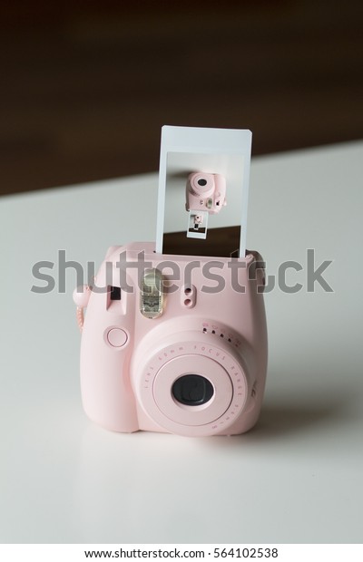 Pink Instant Camera with Film Coming Out Showing\
Shot of Camera