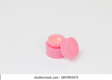 Pink jar with white, pink cream for face, hands, feet, body on a white background. The beauty. The medicine. View from above. Advertising. Place for an inscription. Decorative cosmetics. - Shutterstock ID 1897892473
