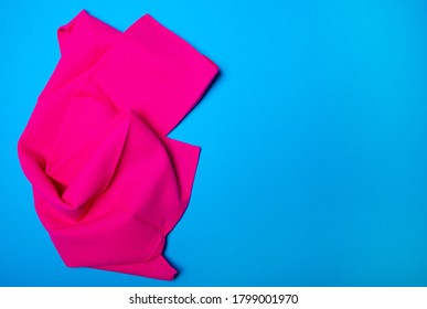 Pink Kitchen Towel On Blue Background, Top View