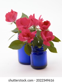 Pink Knockout Roses In Blue Jars