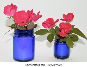 Pink Knockout Roses In Blue Jars