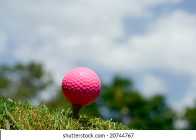 Pink Lady golf ball on a tee