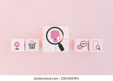 pink lady inside magnifying glass icon on wooden cube blocks with others business icon for buyer persona and target customer concept, buyer or customer psychology profile or characteristics 