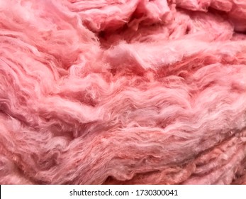 Pink layers of mineral fiberglass used for temperature insulation