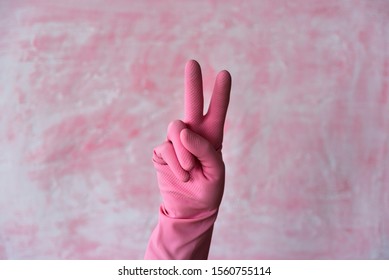 Pink Left Hand In V Sign Peace Gesture. Left Hander Day Concept